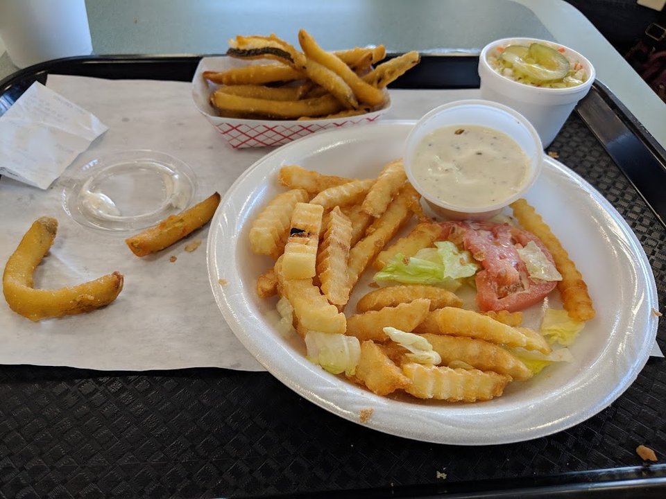 Cheeseburger plate with slaw and onion rings.