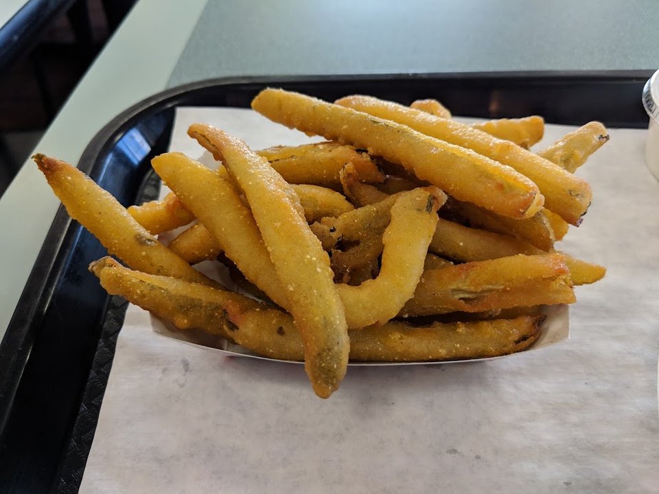 Cheeseburger plate with slaw and onion rings.